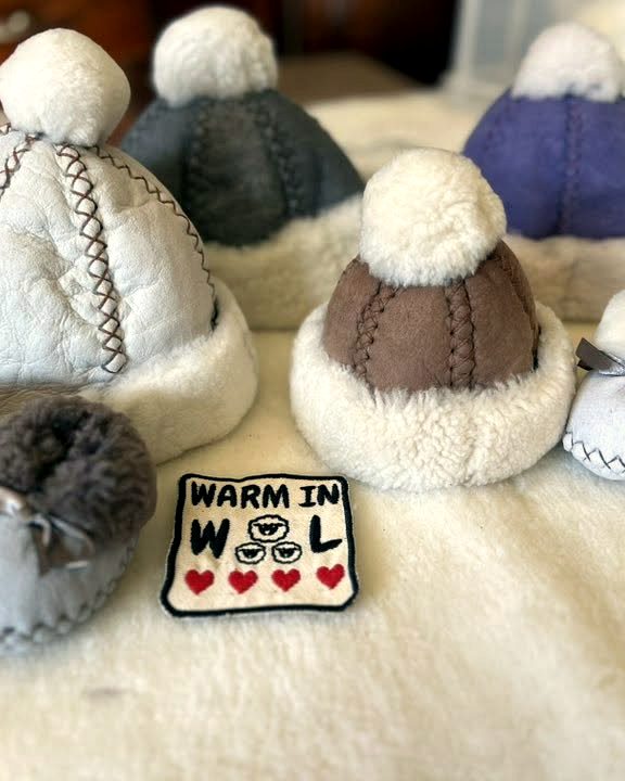 Sheepskin beanies with pompoms