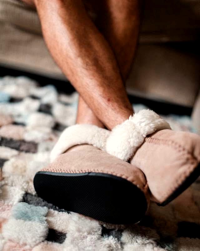 Wearing sheepskin slippers on a rug